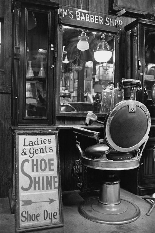 An antique barber shop chair and mirror for sale at United House Wrecking