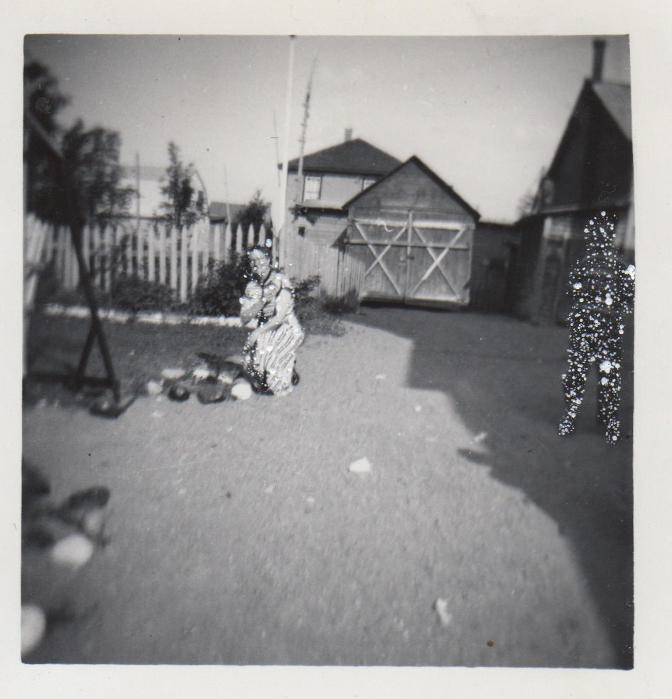 Woman on one knee and boy in shadow