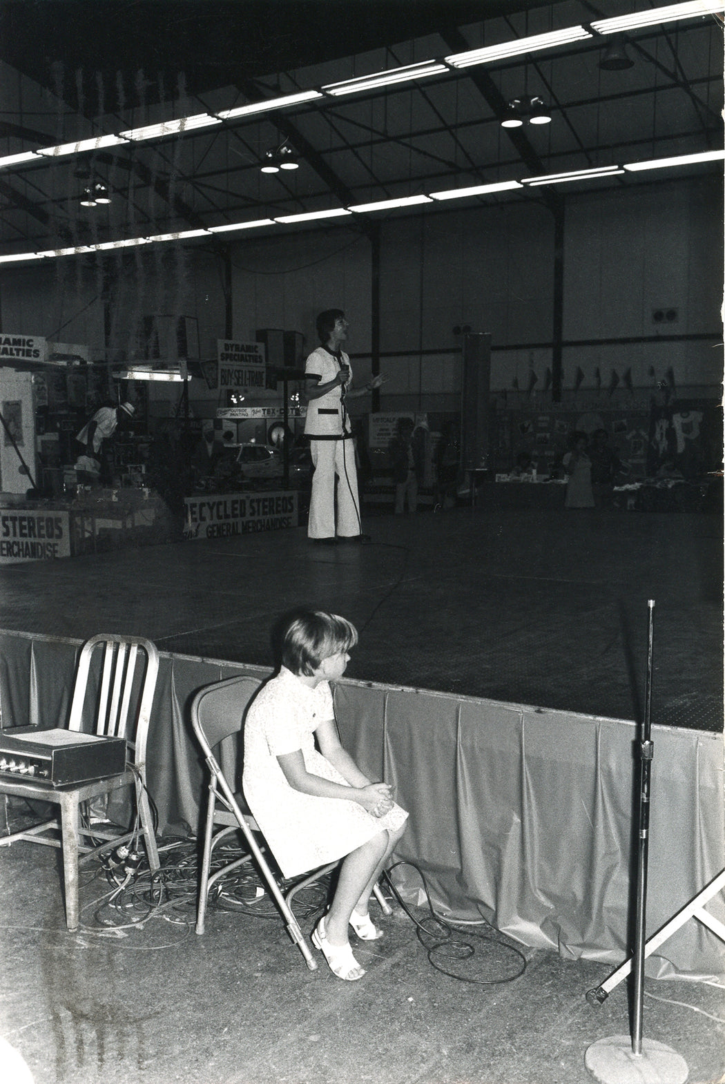 Untitled, San Mateo, California [girl sitting alone by stage]