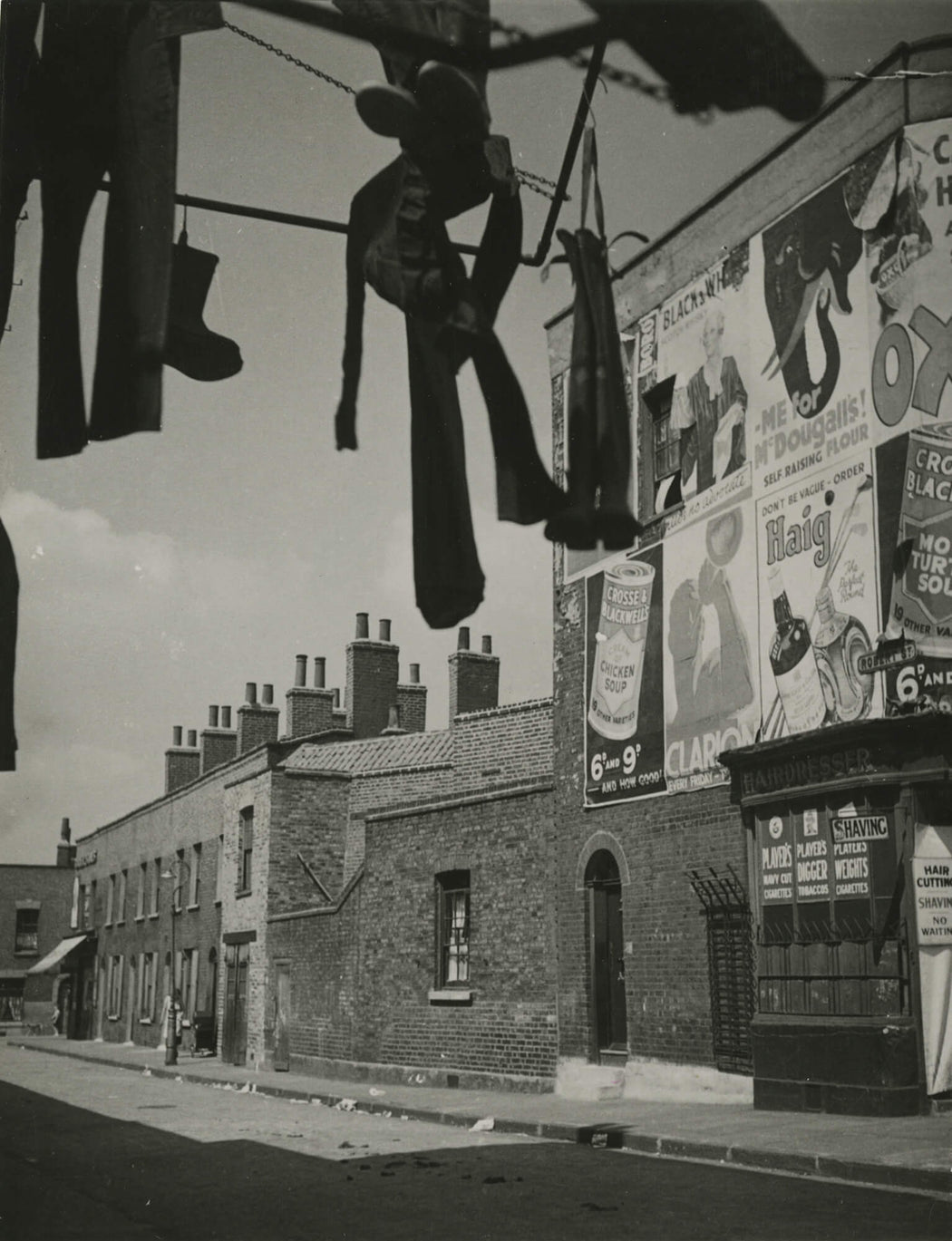 Untitled [street scene with billboard and hanging trinkets]