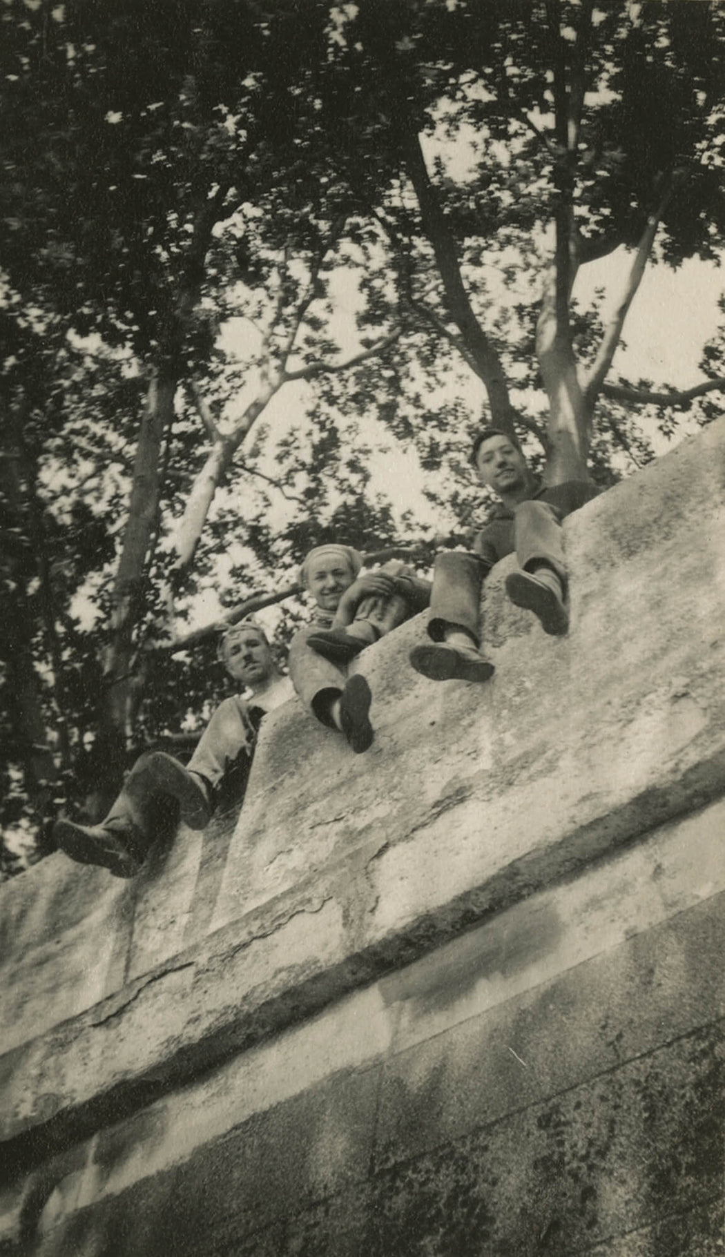 Untitled [children sitting on top of cement wall]