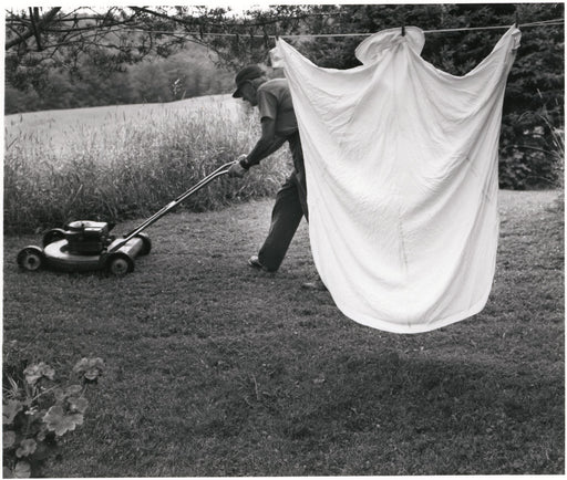 Sheet on Line With Man Mowing Lawn