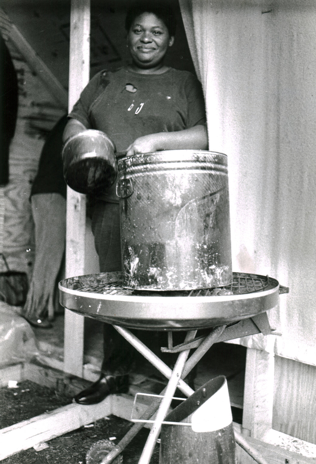Untitled [Woman with large pot on BBQ]