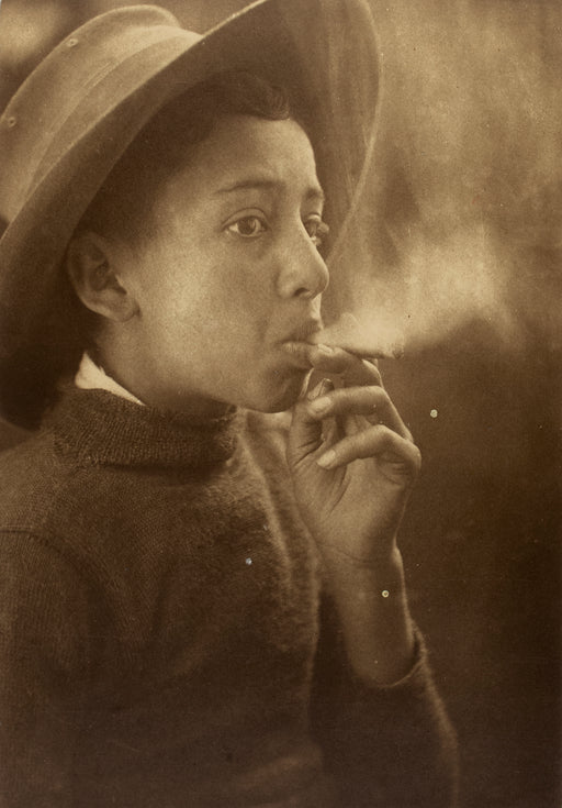 Untitled [Boy smoking wearing a wide-brimmed hat]