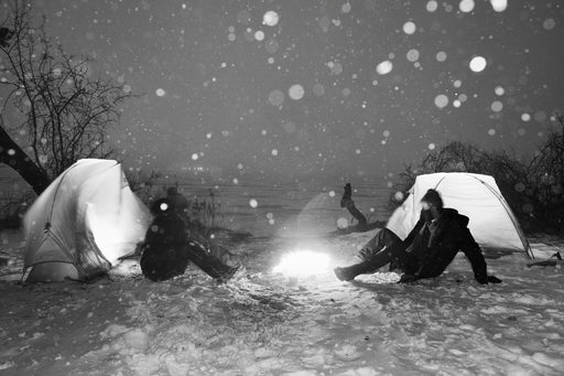 They Sit Silently Facing Each Other Across The Fire